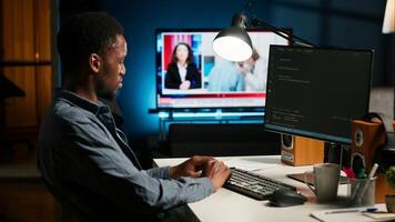 Developer enters binary data on terminal panel and establishing html code. Software engineer working from home on troubleshooting with programming language, encryption. Camera B. photo