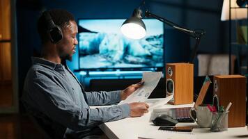 advisor talks to his team on phone call at home office, obtain new business funding from shareholders. Young man doing remote work to increase revenue and reduce cost. Camera B. photo