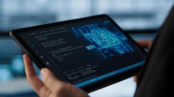 Programmer in data center using AI on tablet, verifying compliance requirements of supercomputers. Server hub worker optimizing resources using device, camera A close up photo