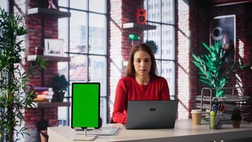 woman solving tasks on a freelance platform next to mockup screen, answering emails and multitasking. Person staying connected and enjoying flexibility of working from home. Camera B. photo