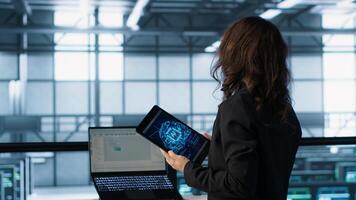Technician using AI tech on tablet to adjust power management settings. Engineer in server room optimizes resource utilization using artificial intelligence, camera A photo