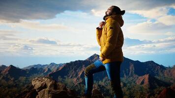 Determined traveler enjoys solitude of summit, where panoramic view represents adventure and personal growth. Hiker feeling cold on windy mountain top. Camera A. photo