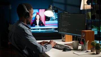 African american programmer working on cloud computing with algorithm, writing code for optimization on terminal window. IT specialist inserts html code, server security. Camera B. photo