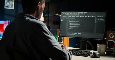Black programmer manages code and scripts in artificial intelligence and machine learning on dual monitors computer setup. Male freelancer uses pc to guarantee cyber security. Camera A. photo