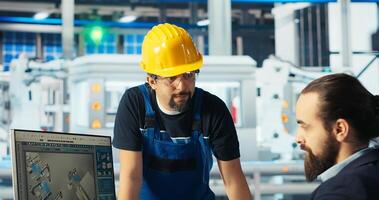 Factory manager delegating tasks to employee, improving solar panels efficiency. Team leader sends worker to make adjustments after researching more sustainable energy solutions, camera B photo