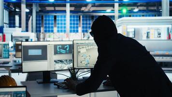 Masked worker in photovoltaics factory commits corporate espionage, stealing proprietary technology. Man exploits insider access to copy trade secrets from solar panel plant, camera A photo
