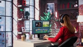 Focused woman works on montage in creative software at home, digital media. Filmmaker using dual monitors to edit footage and create content, post production. Camera B. photo