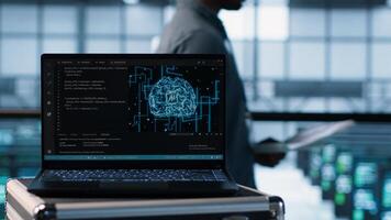 Artificial intelligence coding on laptop in data center with programmers in background employing machine learning models. Notebook used by AI experts, camera A close up photo