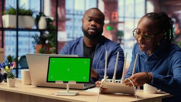 Discouraged black couple struggles with unstable WiFi network, getting angry while troubleshooting to fix error. Stressed people with lots of remote tasks. Camera B. photo