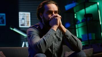 supporter cursing own team for getting defeated during live match broadcast, expressing anger. Mad man throwing pillow in frustration seeing favorite club commit blunder, camera A photo