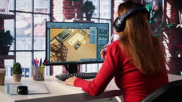 Female employee creates 3D render of apartment interior using blueprints and architectural software. Woman employs computer aided tools and models to allow customization of flooring. Camera B. photo