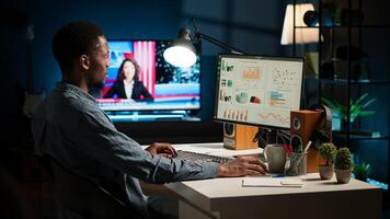 Male analyst studying digital commerce progression reports on computer, working at home to boost earnings and gain shareholder backing. Specialist analyzes company information. Camera A. photo