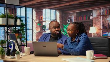 Tech savvy people working on laptop to test new software, navigating digital tools and managing virtual tasks. Connected and productive lifestyle at home. Camera A. photo