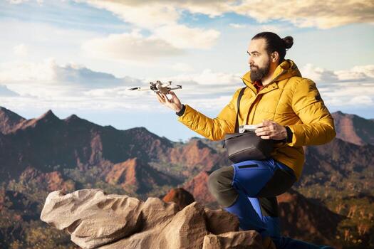 Trekking enthusiast captures activity using drone footage, documenting scenic mountain range valley. Filming beautiful aerial view vlog with remote control device. photo