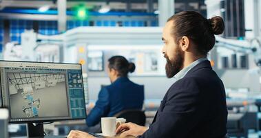 Photovoltaics engineer looking over documents and analyzing data. Solar panels manufacturing plant employee reading documentation files, troubleshooting technical issues, camera B photo