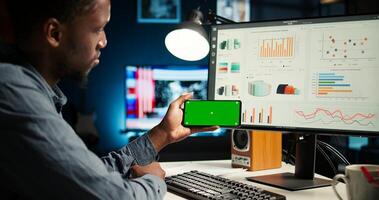 Person does remote work using data finances with green screen, examining statistics at workstation. Investment advisor planning new strategy to obtain funds for development. Camera A. photo