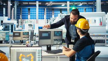 Solar manufacturing plant manager showing engineer on PC how to develop prototypes for solar energy systems. Team leader telling technician about new photovoltaics materials, camera A photo