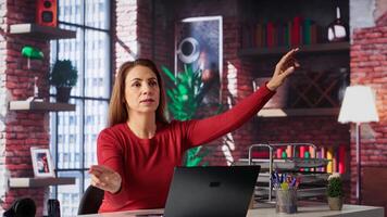 Freelancer reviewing holographic images with digital AI innovation, looking at hologram projection at home. Woman employs artificial intelligence visualization. Camera A. photo