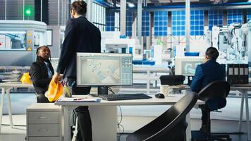 Manager arriving at work in photovoltaics factory, analyzing data, reviewing system metrics. Man in eco friendly solar panels plant producing renewable energy troubleshooting technical issues photo