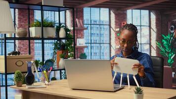 African American woman rebooting WiFi modem by pulling out cables, checking with internet provider for support. Troubleshooting ongoing connectivity issues. Camera A. photo