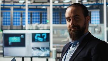 Portrait of man using laptop to improve efficiency in solar panels plant. Photovoltaics factory research expert using notebook, working on green energy solutions, camera A photo