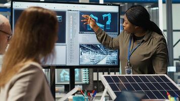 Engineering team in photovoltaics plant improving solar cells efficiency. Smart factory research and development department staff working on clean energy solutions, camera B photo