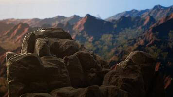 Panoramic view of stunning mountain range with rocky terrain in foreground. Perfect for adventure seekers looking for extreme hiking experience in heart of untouched wilderness. photo