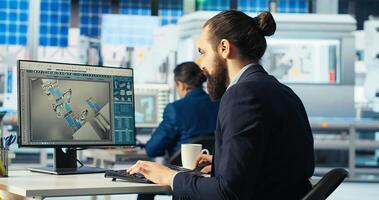 Factory engineer analyzing data on desktop PC, reviewing system metrics. Solar panels plant employee troubleshooting technical issues at computer desk, diagnosing faults, camera B photo