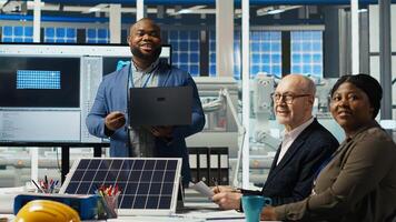 Portrait of smiling photovoltaics scientists experimenting with advanced PV materials to improve solar panel durability. Researchers developing efficient sustainable energy solutions, camera B photo
