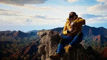 Traveler in warm clothing reaches peak with deep sense of satisfaction, feeling tired but proud of achievement. Adventure seeker accomplishing a goal. Camera A. photo