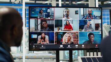 Photovoltaics plant shareholders analyze market trends during videocall to determine investment strategy. Managers in teleconference meeting look at data, expanding factory production, camera B photo