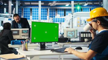 Engineer in solar panels plant using CAD software on mockup PC to optimize layouts. Factory worker using green screen computer making arrangements for maximum energy output, camera A photo