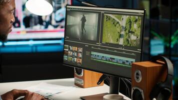 Editor working on creative software to create montage, using color correction and adding visual effects. Content creator editing graphics and gradient for movie post production. Camera B photo