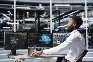 Data center engineer using machine learning algorithms on computer to analyze vast datasets to recognize emerging trends and predict future patterns based on historical data photo