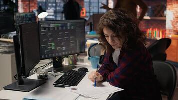 Tech startup HR employee analyzing candidates for job opening, reviewing resumes to determine skills. Woman screening people for software development Silicon Valley company position, camera A photo