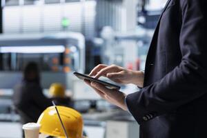 Operations director in a solar panel factory monitoring efficiency metrics and system outputs, combining leadership with real time quality inspection and strategic business development. photo
