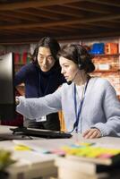 Asian call center senior manager providing guidance to intern, addressing questions. Experienced customer support workplace onboarding specialist conducting orientation sessions for new agent photo