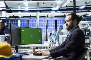 Male innovation consultant explores engineering upgrades with mockup in a solar panel facility, sustainable energy improvements and modern manufacturing processes for development. photo