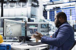 Black building contractor reviews solar tech systems on files and pc, supporting assembly and production line. Modern energy systems with sustainable solutions for green technology. photo