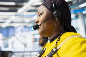 Helpline worker troubleshooting errors in solar production systems using headset, woman providing support for photovoltaic malfunctions or technical issues in renewable energy plant. photo