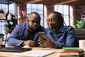 African american couple at home office participating in a teleconference for remote workshop, maintaining a strong digital connection for an effective online course. Virtual call. photo