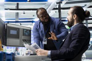 Multiethnic team of engineering specialists working together for solar power manufacturing process, strengthening infrastructure and business development. Renewable energy in a plant. photo