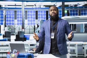 Black director hosting a meeting to discuss renewable energy production, ensuring quality control tests and sustainable solutions for cheaper solar power. Manage industrial operations. photo