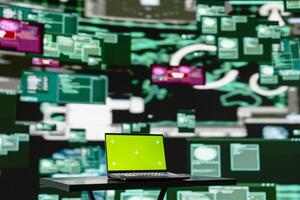 Empty scene with green screen on laptop showcases quantum threat on the dark web, space for a cyber crime with system override and identity theft. Cracking passwords to steal data. photo