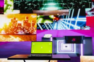 Empty scene with a pc showcasing copy space display next to artistic lights, creating a soundscape for nightlife ambiance and music culture. Spreading the visual art vibes and creativity. photo