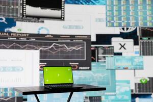 In a business finance space, laptop showing isolated chroma key to help the strategy planning with financial data. Representing high tech artificial intelligence and productivity for growth. photo