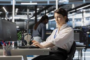 Data center computer scientist uses PC to update servers tech, configuring gear using software. Server hub IT professional reviewing hardware analytics, ensuring reliable network operations photo