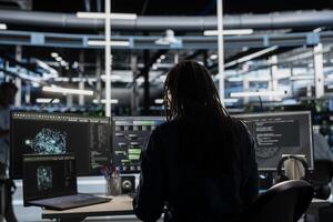 Data center admin looks at AI visualization dashboard on laptop to pinpoint equipment performance issues. Server farm specialist looks at data analysis graph on notebook to reduce hardware failures photo
