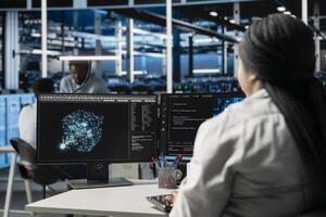 Data center computer scientist at work using machine learning algorithms to analyze datasets. Server room staff member using artificial intelligence to recognize data patterns photo