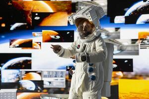 Young male cosmonaut drifting in zero gravity during a space walk, reflecting interstellar adventure, celestial wonder and the future of astronautics and planetary discovery. Space craft. photo